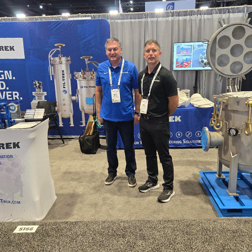 Fil-Trek representative speaking with attendees at WEFTEC